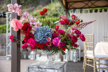 Flower arrangement of bright colors in a glass vase. Wedding floristry