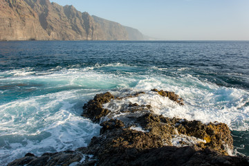 Waves crashing into spectacularly shapped vulcanic coastline.