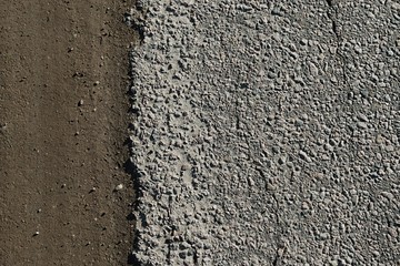 Road with a lot of cracked asphalt parts together next to ground