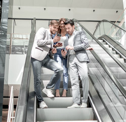 employees of the company looking at the screens of smartphones