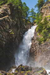 Naklejka na ściany i meble beautiful waterfall in a wood on the Italian Dolomites