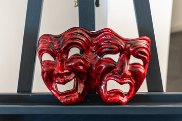 red carnival mask representing joy and sadness