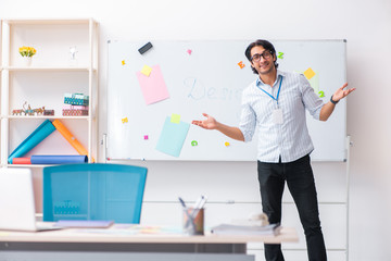 Young handsome male designer working in the office 