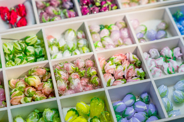 multicolored mix of lampwork beads on a tray for making necklaces or bracelets, DIY materials