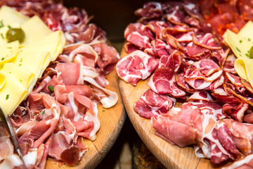 Appetizer. Wooden board with prosciutto, salami and cheese