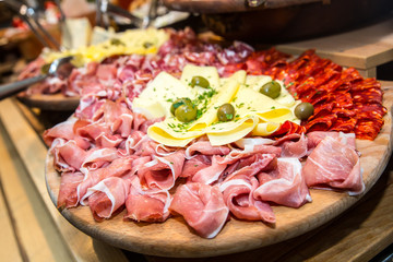 Appetizer. Wooden board with prosciutto, salami and cheese