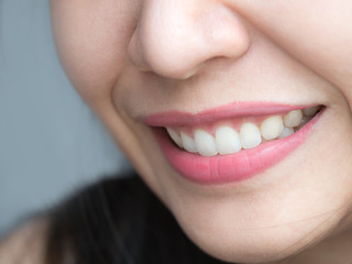 Closeup shot of Asian Chinese Thai woman female makeup face. Woman with red lips lipstick and healthy dental white great perfect teeth. Smiling, Dental dentist clinic concept. mouth open. wisdom tooth