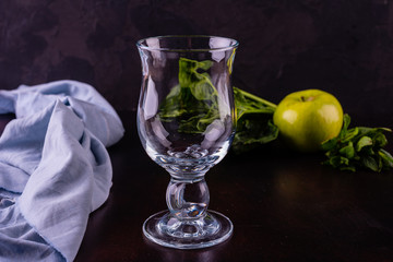 Ginger green apple smoothie on concrete background. It can be used as a background