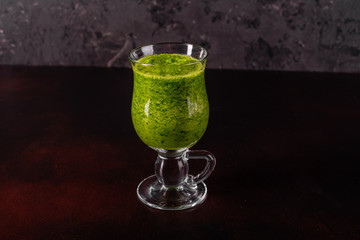 Ginger green apple smoothie on concrete background. It can be used as a background