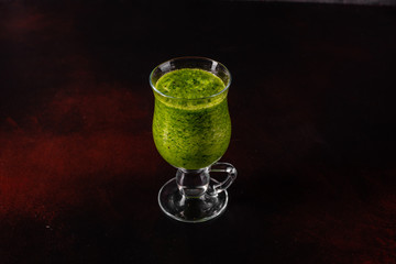 Ginger green apple smoothie on concrete background. It can be used as a background