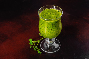 Ginger green apple smoothie on concrete background. It can be used as a background