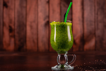 Ginger green apple smoothie on concrete background. It can be used as a background