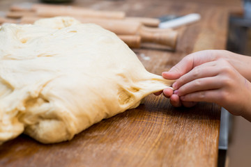 Young children make dough products. Hands closeup