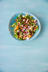Arugula, apple, orange, pomegranate, goat cheese. Salad of ruccola, goat cheese, fruit with olive oil. Light breakfast 