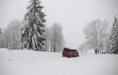 car in a ditch, difficult road conditions - snow and fog