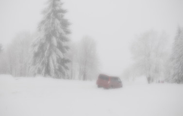 car in a ditch, difficult road conditions - snow and fog