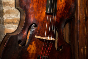 Vintage contrabass on wooden floor