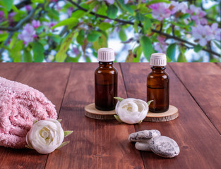 Aromatherapy oils, small stones, pink towel