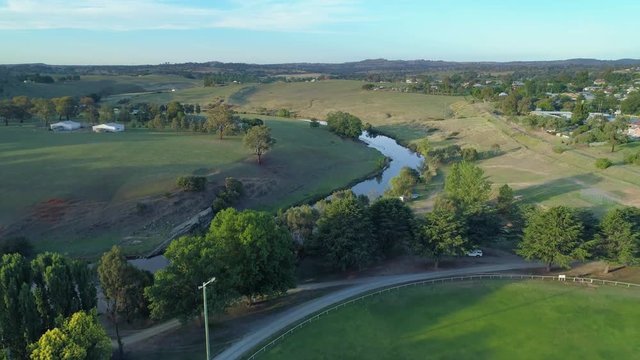 Slow rise revealing scenic countryside landscape with meadows and winding river in Yass, Australia