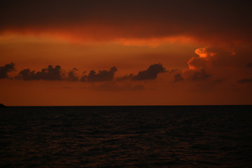 Fototapeta premium Fiery orange sunset over the sea