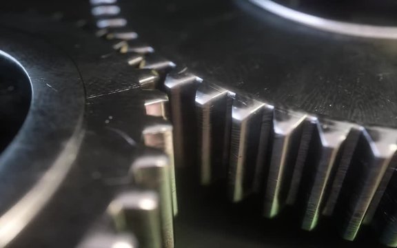 Metallic gear symbol on a dark background. 3d gear mechanism.