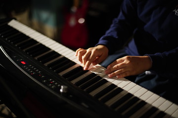 Obraz na płótnie Canvas Hands playing on musical instrument | Student learn to play Electric piano