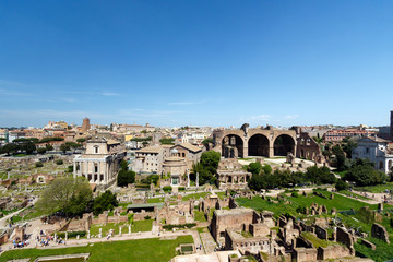 Fototapeta na wymiar Wide angle view of the Roman Forum, with the The Basilica of Maxentius and Constantine, sometimes known as the Basilica Nova prominent in the picture 