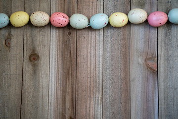 Flat lay speckled easter egg spring concept on a wood background