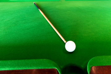Cue and ball on the pool table.