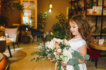 Mom and son with flowers in caffe. Son give flowers to mother. cute family. International women`s day, 8 march celebrating