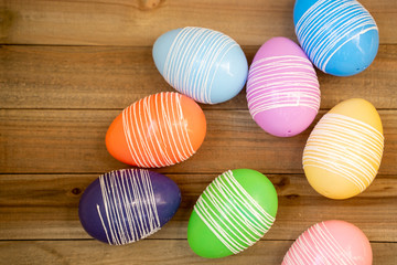 Colorful pastel easter eggs on a wood background. Flatlay (flat lay) background for spring
