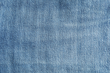 Naklejka premium Texture of blue jeans as background, space for text