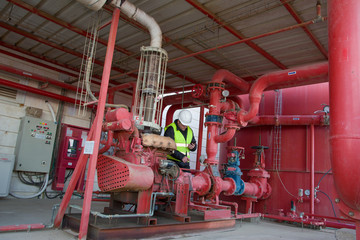 Engineer inspecting machinery water pump. checks the pump sprinklers