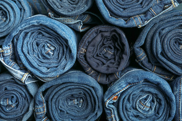Background of a stack rolled jeans, space for text