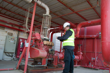 Engineer inspecting machinery water pump. checks the pump sprinklers