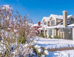 A typical american house in winter. Snow covered.