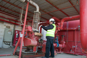 Engineer inspecting machinery water pump. checks the pump sprinklers