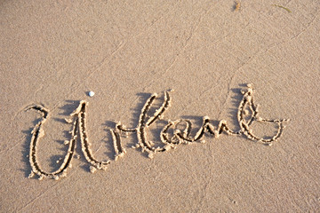 vacation word in beach sand