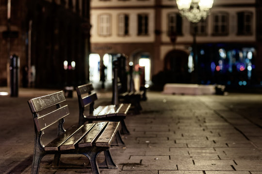 Lonely empty benches on night street in Strasbourg center