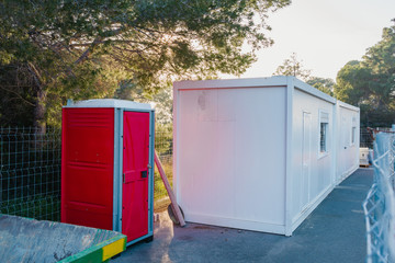 .Construction Site Living Container. Outdoor portable red toilet. WC.