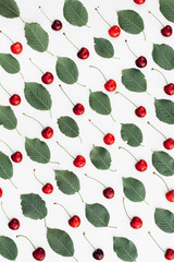 Fresh red cherry and leaf pattern on white background. Spring and summer concept. Flat lay, top view, copy space