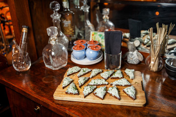 Photo of wooden board with sandwiches.