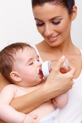 Sleepy baby with feeding bottle