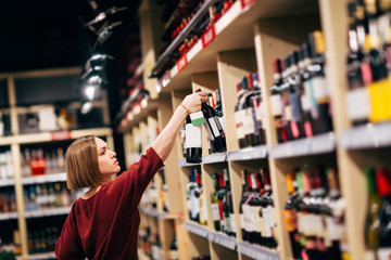 Photo of young woman in wine shop