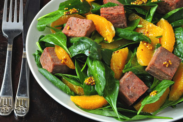 Super salad with spinach, orange and salmon. Healthy colorful fitness salad. Keto recipe idea.