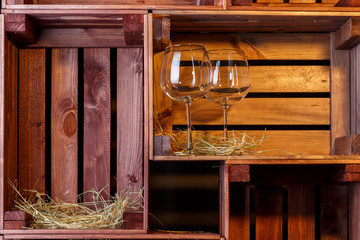 Photo of two wine glasses in wooden boxes.