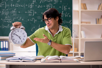 Handsome student in front of chalkboard with formulas 