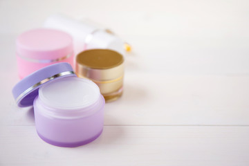 cosmetic and skin care product on white wood table, beauty with treatment cream and moisturizing on wooden desk, health and wellness concept.