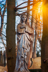 Virgin Mary antique statue. Vintage sculpture of sad woman in grief