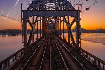 A view of the Railway Bridge over Daugava River during Sunset in Riga, Latvia